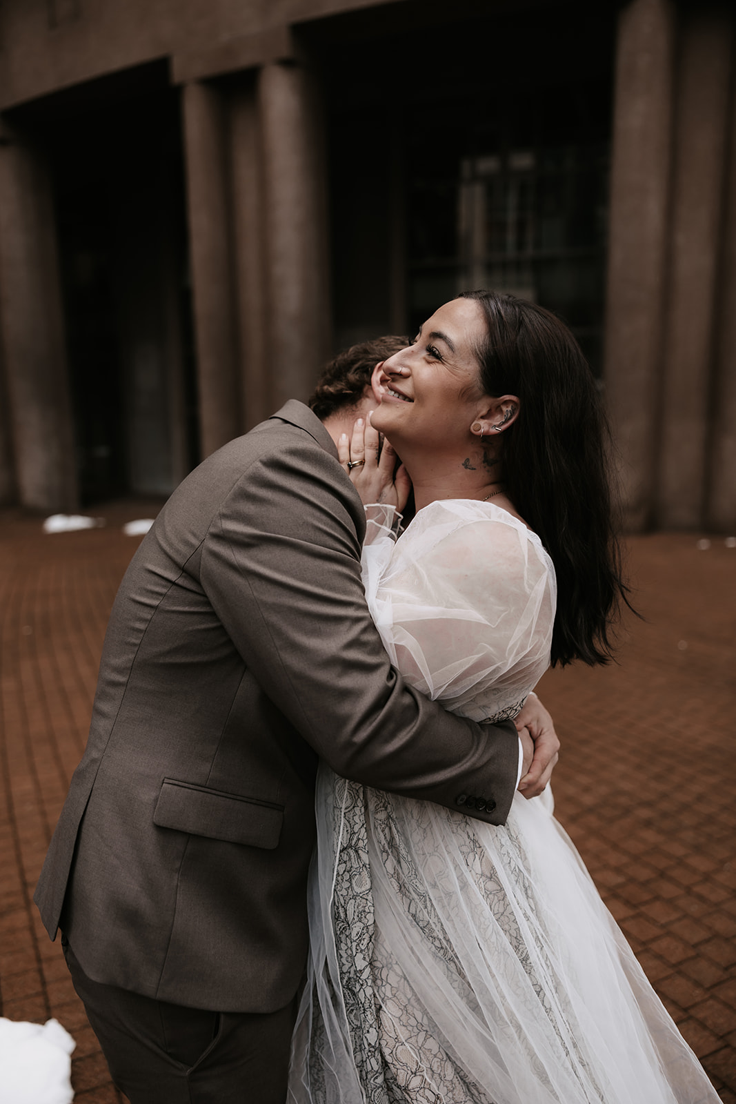 Bride laughing while the groom embraces her, a candid and joyful moment during their Vancouver elopement.