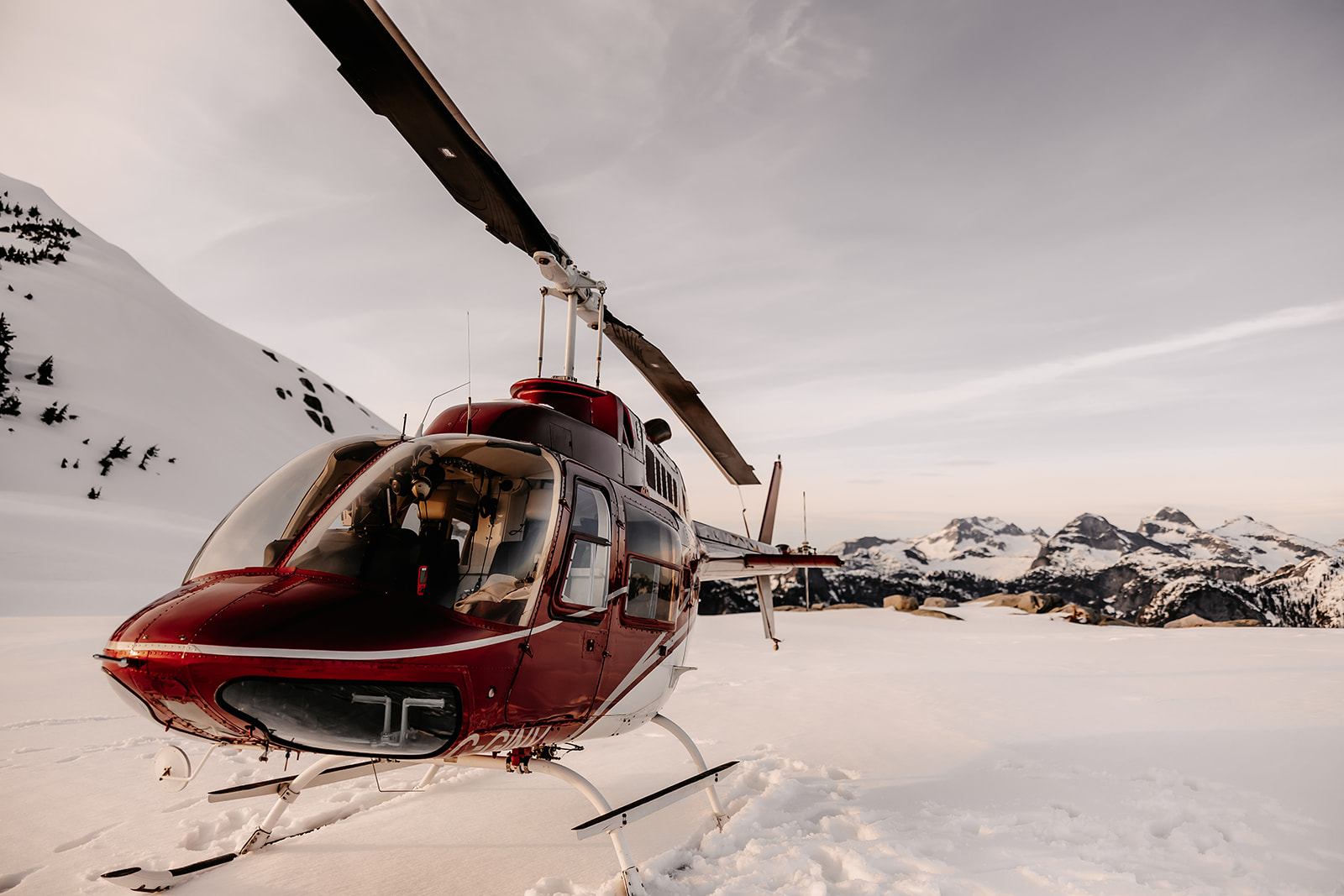 Close up shot of a red helicopter in the snow in BC, Canada