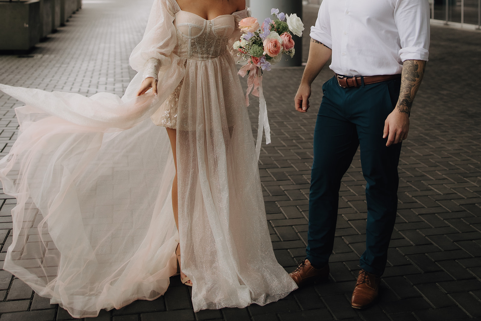 The couple continues to enjoy their downtown Vancouver elopement with a playful moment, where the bride spins around in her dress, creating a carefree, romantic vibe.