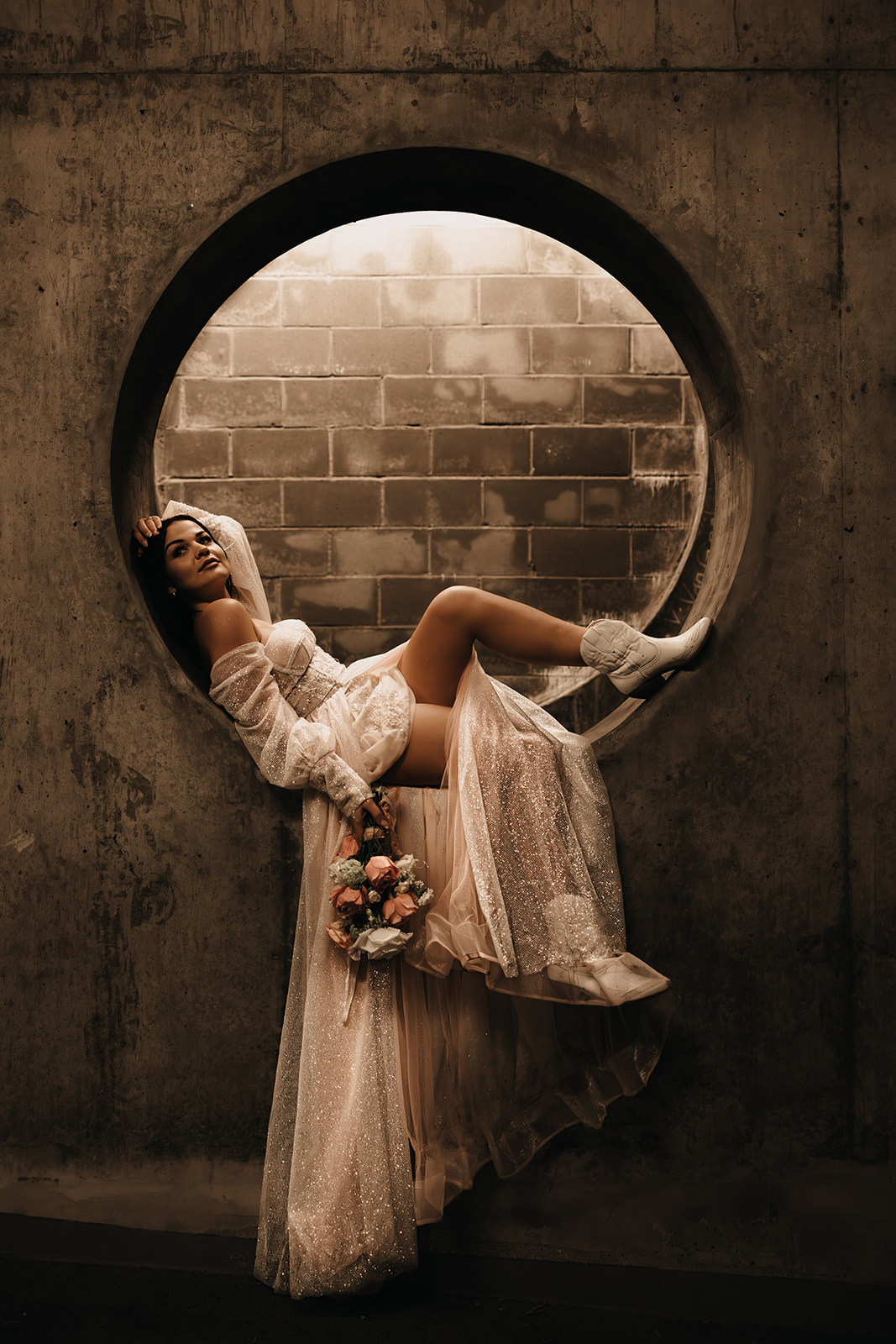 Bride posing in a flowy elopement dress in an underground parking garage for her Vancouver elopement