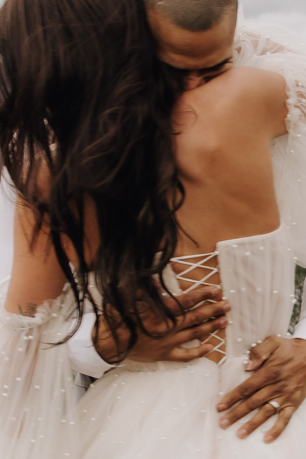 Close-up shot of the couple sharing a sweet moment during their Okanagan elopement, with the groom holding the bride as they embrace by the lakeside.

