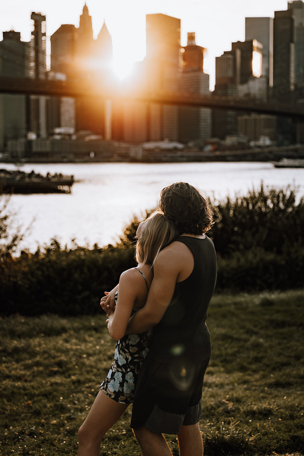 A candid shot of the couple with the sun setting behind them, capturing a magical moment from their new york city couple photoshoot.