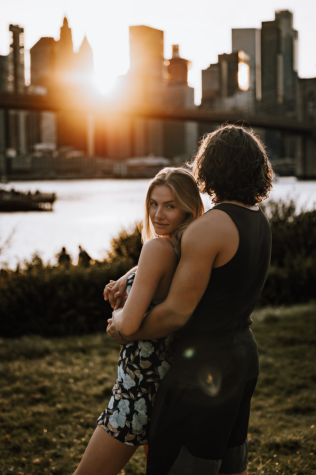 The couple sharing a sweet moment with the Manhattan Bridge behind them, embodying the spirit of love in a new york city couple photoshoot.