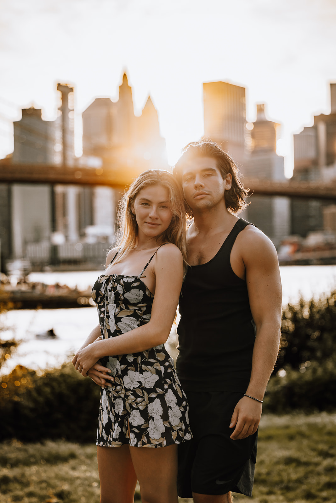 A scenic view of the couple posing with the iconic NYC skyline behind them, showcasing the magic of their city couple photoshoot.
