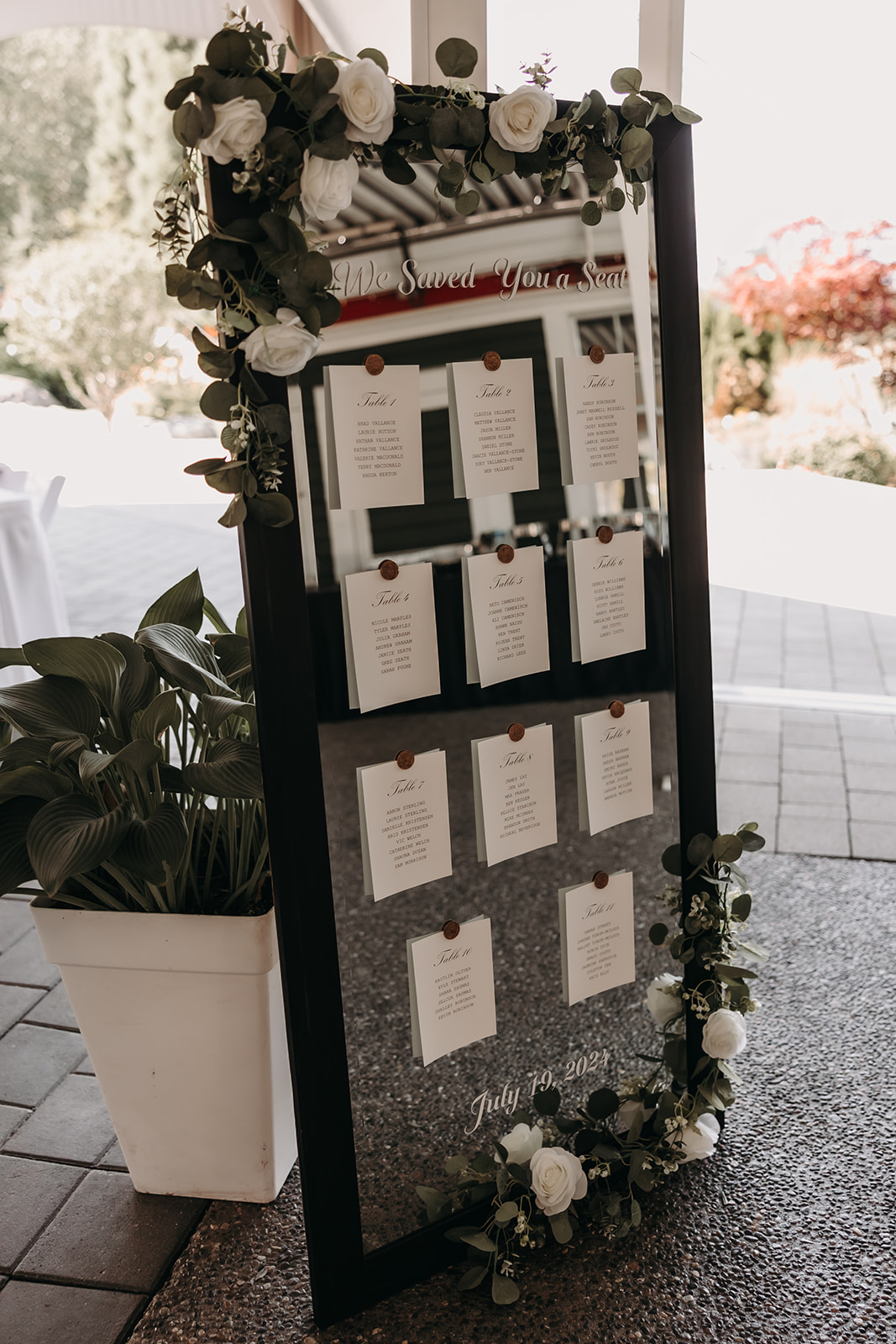 Elegant seating chart display at a Redwoods Golf Course wedding, decorated with fresh flowers and a rustic design.