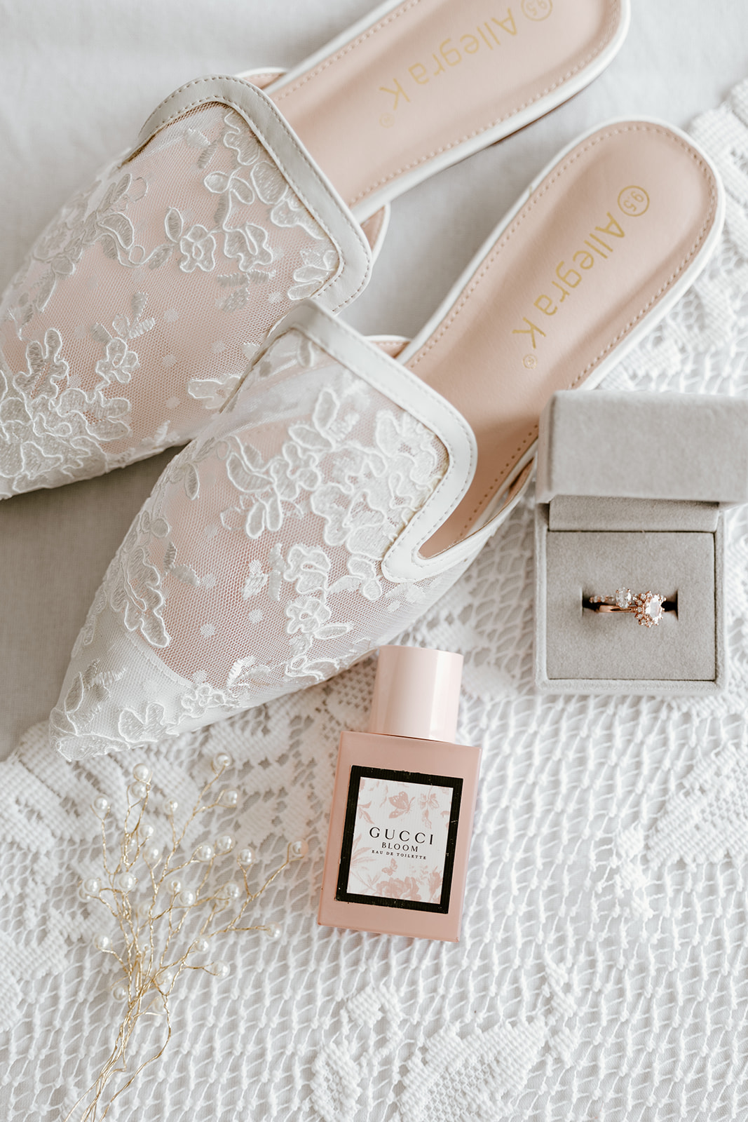 Wedding details including the bride’s shoes, perfume, and engagement ring, highlighting the personal touches in their destination wedding in Maine.