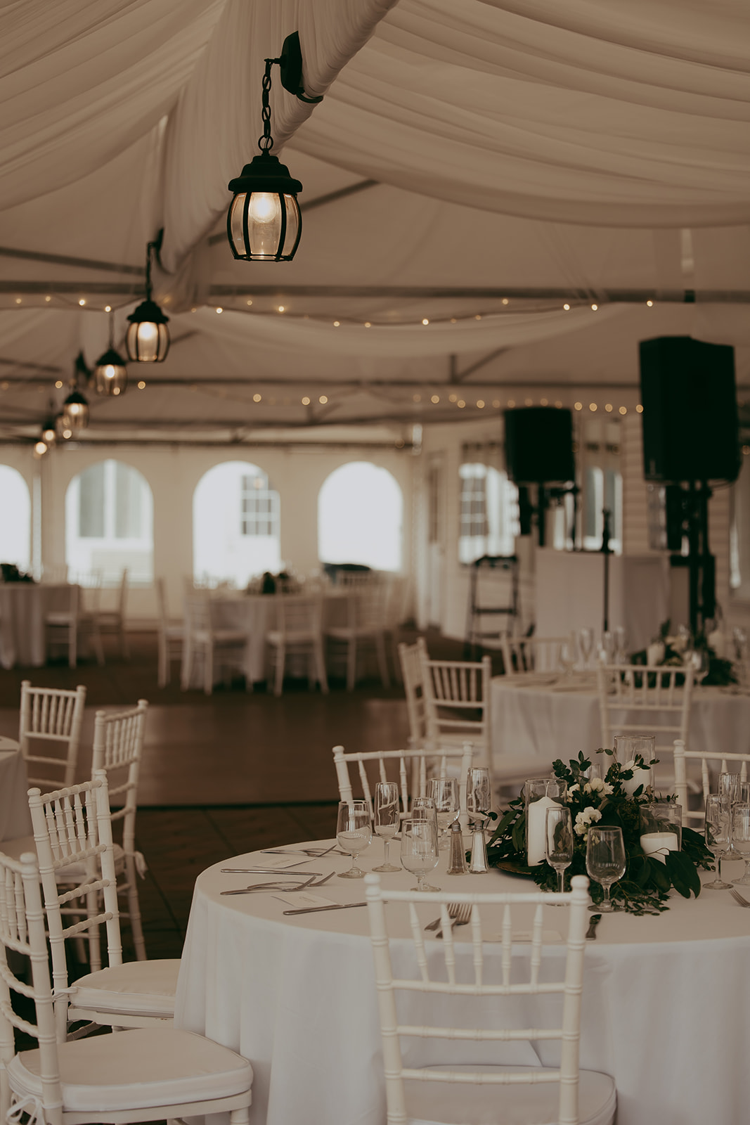 The elegant reception setup featuring beautiful floral arrangements and candles for a destination wedding in Maine, creating a warm and inviting atmosphere