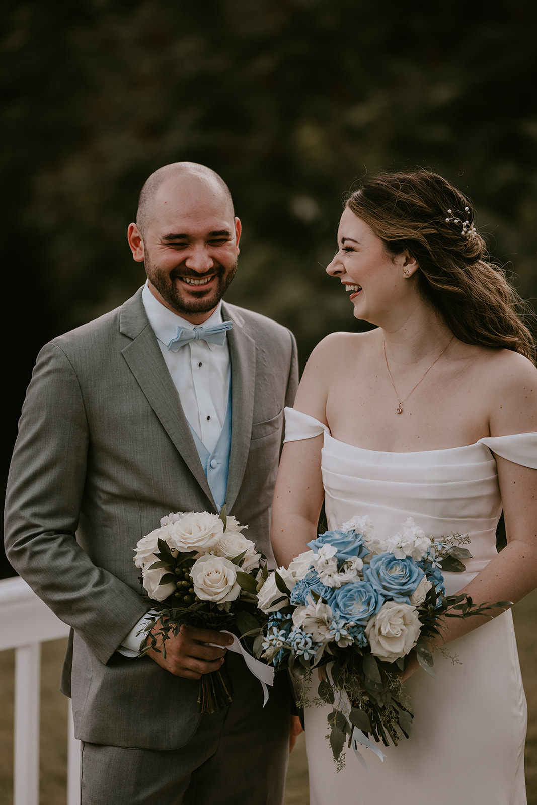 The bride and her friend share a joyful laugh, capturing the fun and relaxed atmosphere of this intimate destination wedding in Maine.