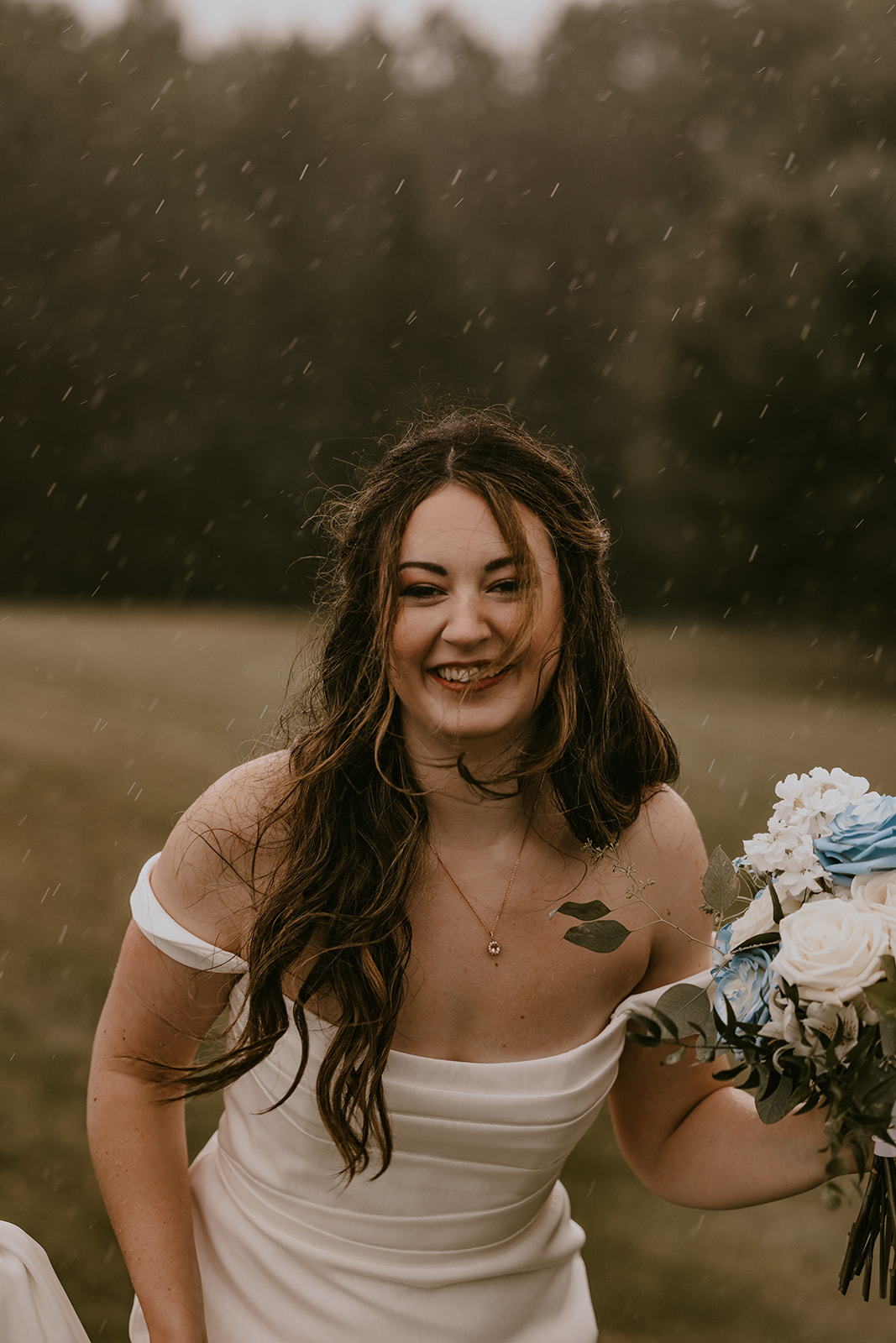 Bride and groom enjoying the rain together, walking hand in hand at the Lucerne Inn, an intimate and memorable moment from their destination wedding in Maine.