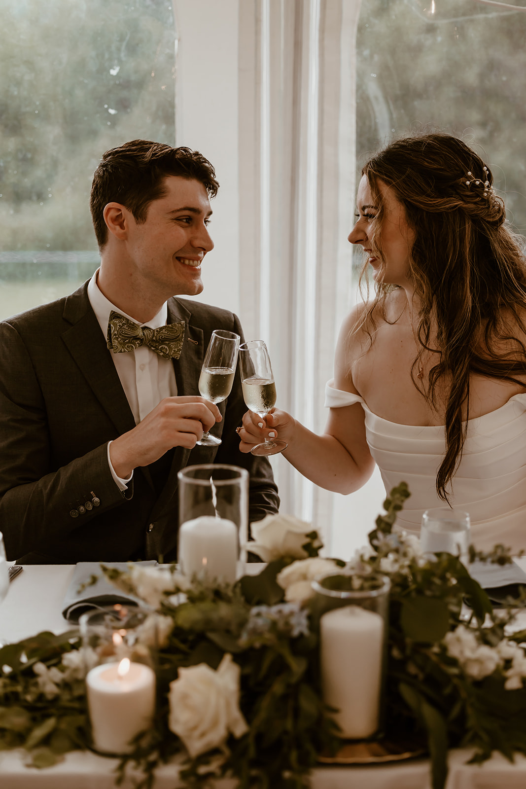 Bride and groom toasting their drinks together during their wedding reception