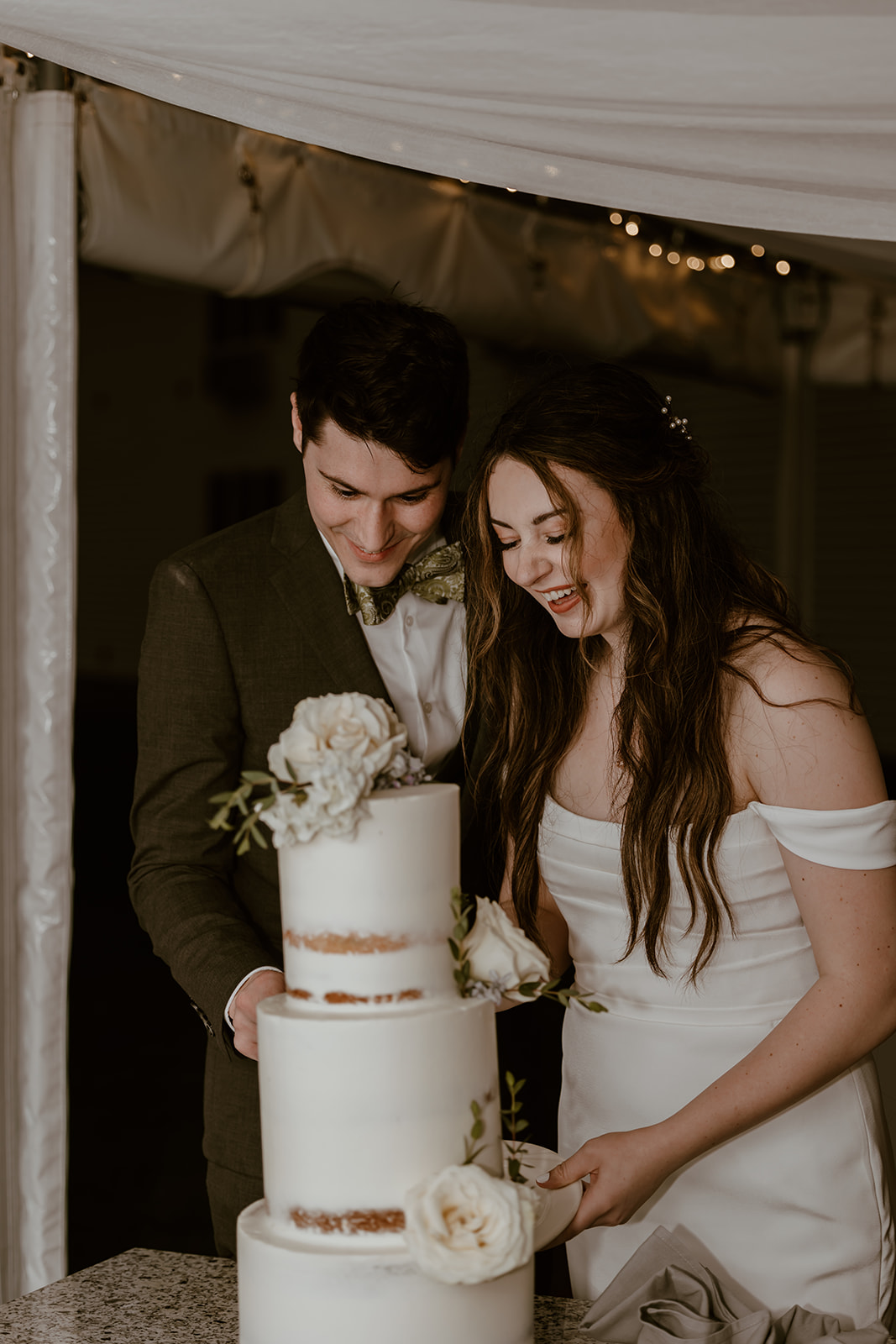 Bride and groom cutting their wedding cake