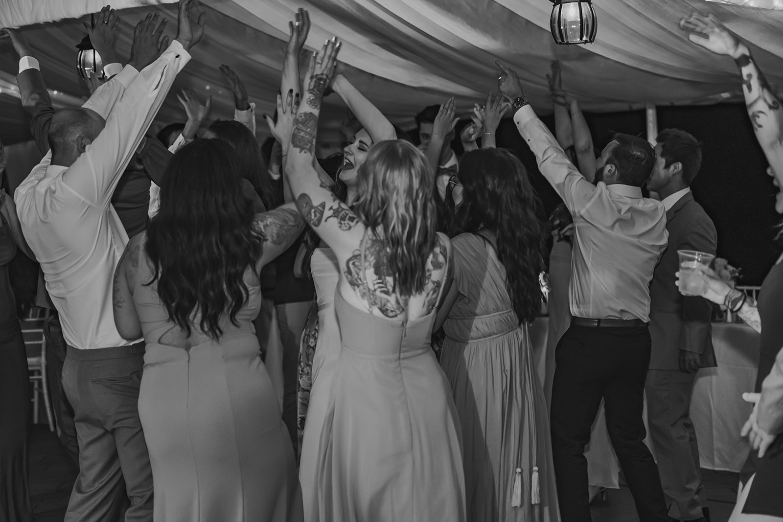 Guests enjoying the energetic atmosphere of the wedding reception, celebrating with laughter and dancing at the Maine destination wedding of Morgan and Ethan