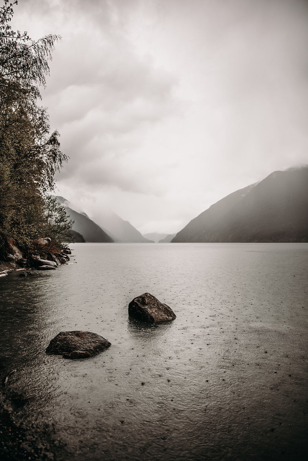 Rainy view of a lake and mountains at Golden Ears Provincial Park during a rainy engagement session.