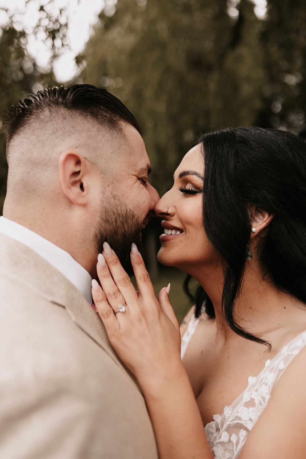 Close up of bride and groom smiling at eachother