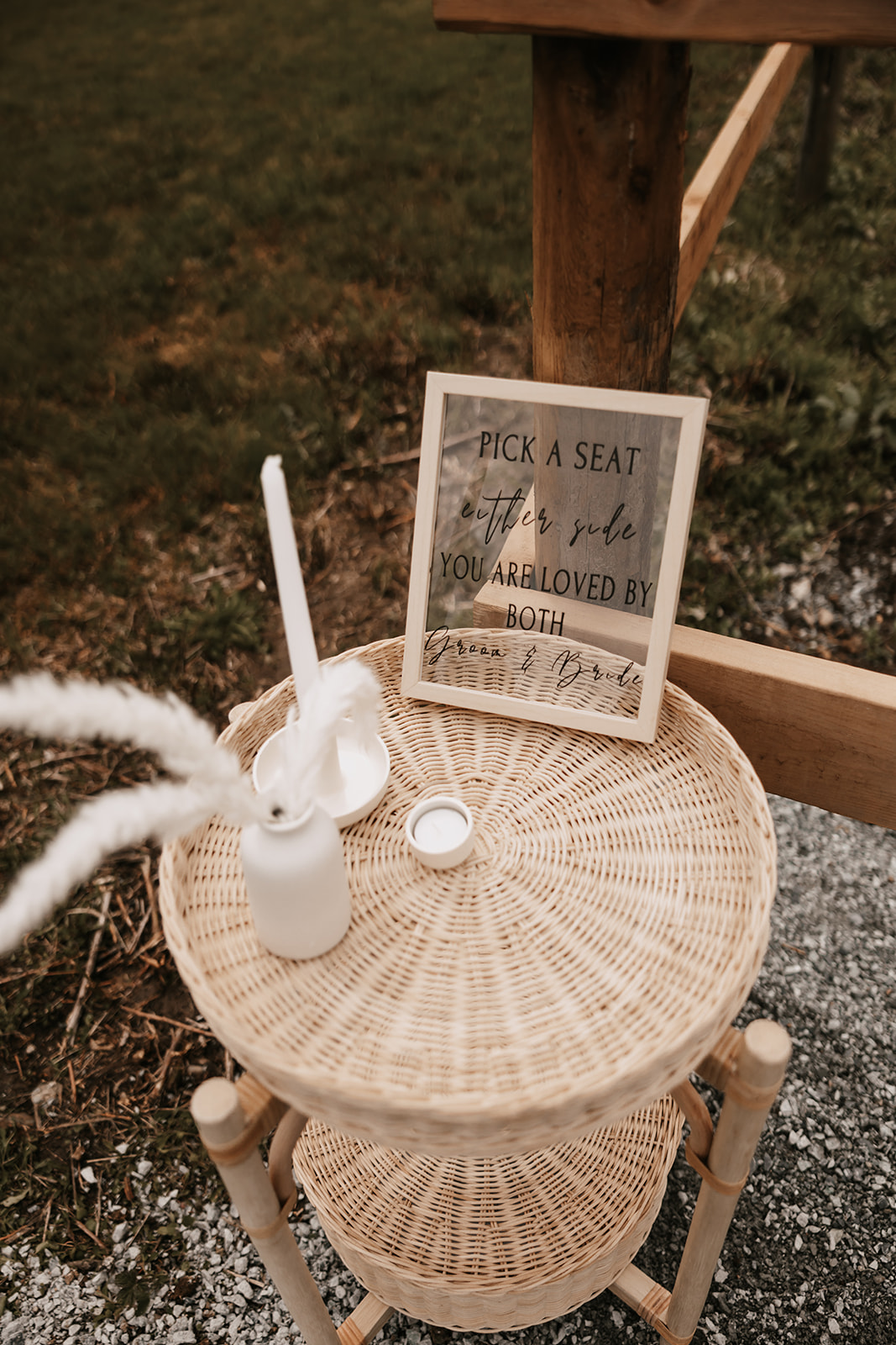 A wedding sign that encourages guests to pick a seat, with the message 'Pick a seat, either side, you are loved by both'. This sign adds a personal touch to the celebration, making guests feel part of the intimate celebration and enjoy the wedding day vibe