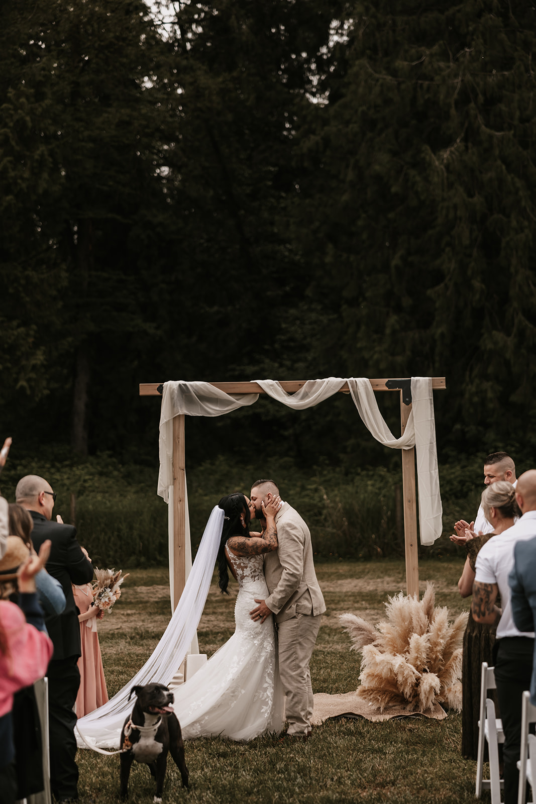 The couple shares a kiss after being pronounced married, with guests clapping in celebration. The feeling of joy and love is palpable—reminding you that your wedding day is all about embracing happiness and celebrating your love.