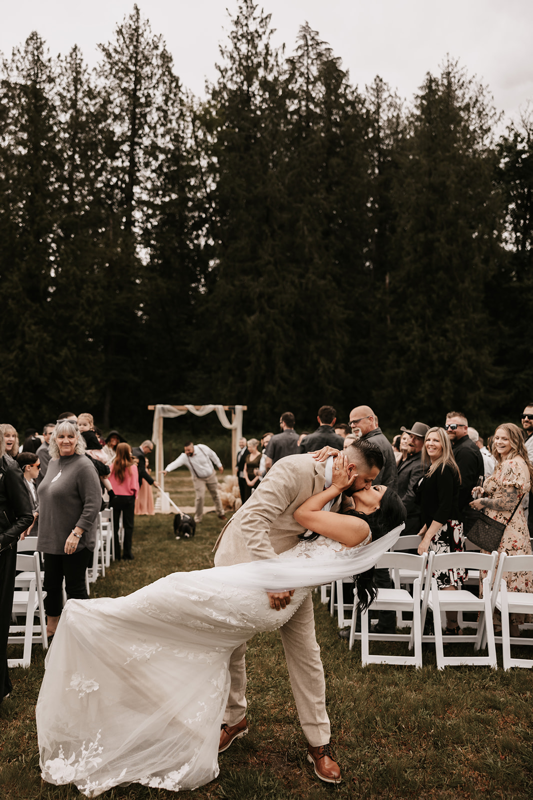 The couple shares a kiss after being pronounced married, with guests clapping in celebration. The feeling of joy and love is palpable—reminding you that your wedding day is all about embracing happiness and celebrating your love.