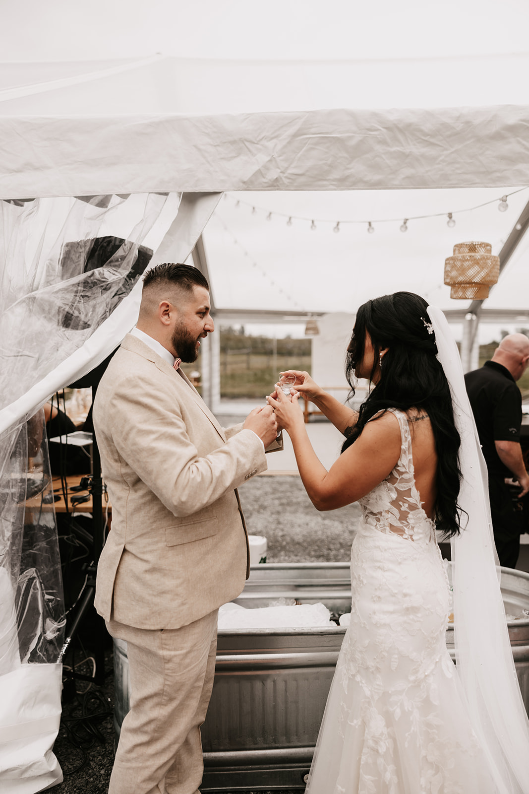 Bride and groom smiling and toasting each other during their wedding celebration, showcasing how to enjoy your wedding day with fun moments and close connections.