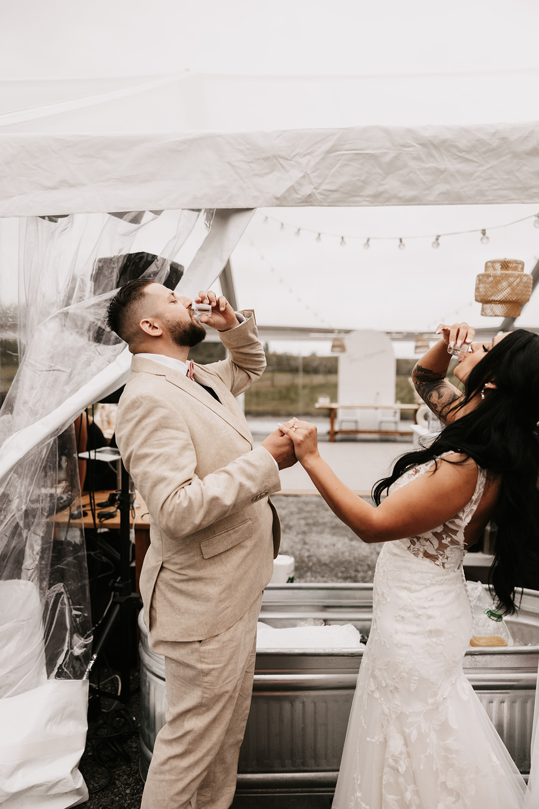 Bride and groom smiling and toasting each other during their wedding celebration, showcasing how to enjoy your wedding day with fun moments and close connections.