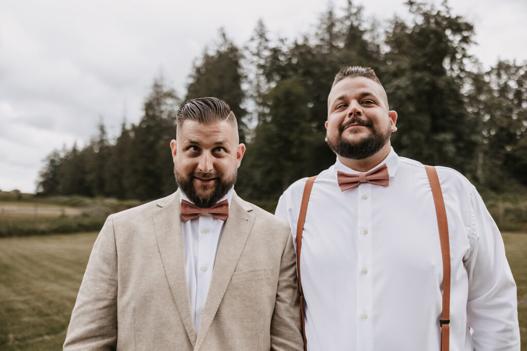 Groom and friend making silly faces