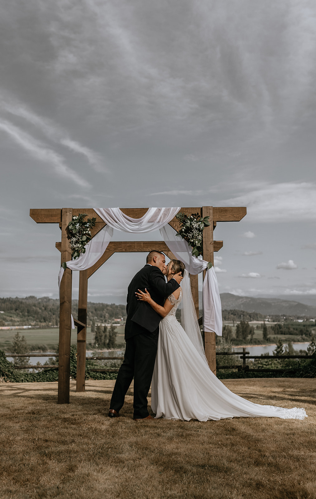 The newlyweds share a kiss after being declared husband and wife at their intimate backyard wedding, surrounded by family and friends.