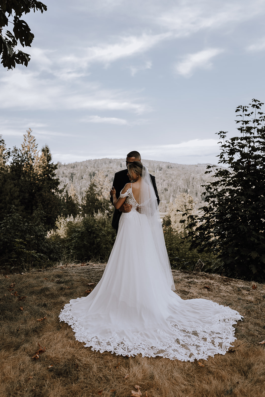 A stunning view behind the couple at their backyard wedding in the Fraser Valley, showcasing love and natural beauty in one perfect shot.