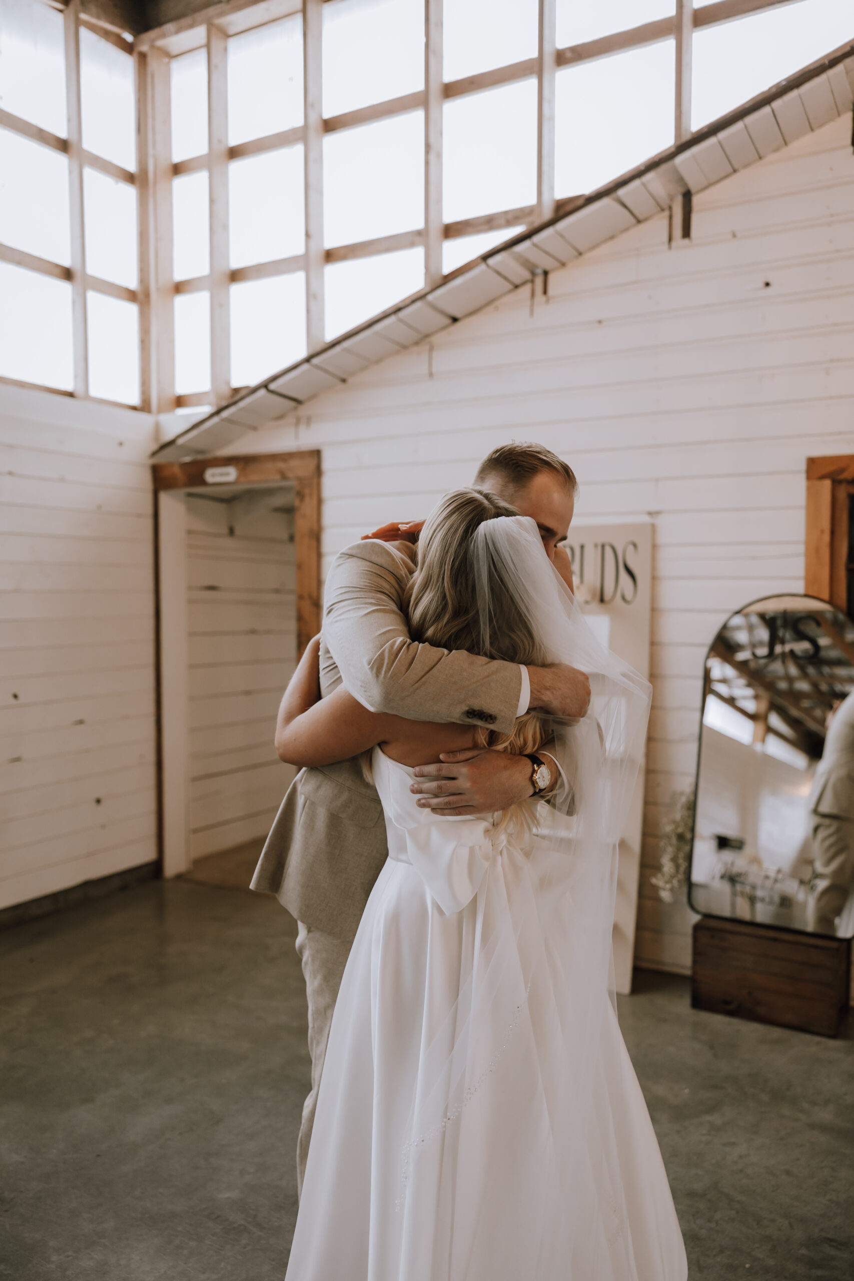 Groom hugging his bride after their first look