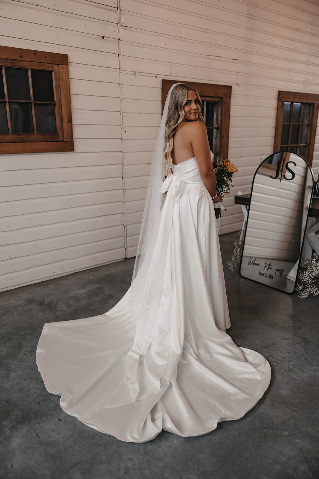 Bride looks radiant in her wedding dress, with a confident smile, demonstrating how a stress-free wedding day lets you enjoy all the excitement and beauty of your big day.