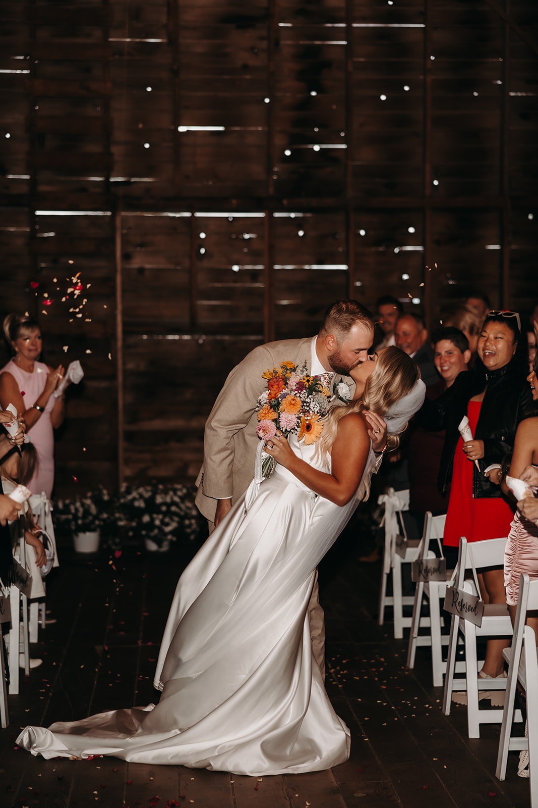 The couple shares a kiss at the end of their ceremony, enveloped by confetti. This beautiful moment captures the joy and excitement of their stress-free wedding day.