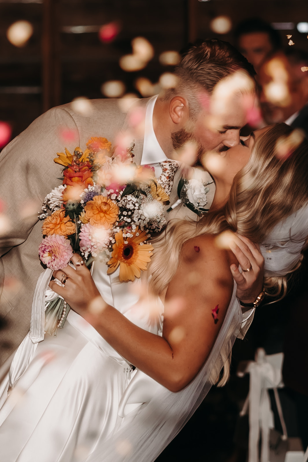 The couple shares a kiss at the end of their ceremony, enveloped by confetti. This beautiful moment captures the joy and excitement of their stress-free wedding day.