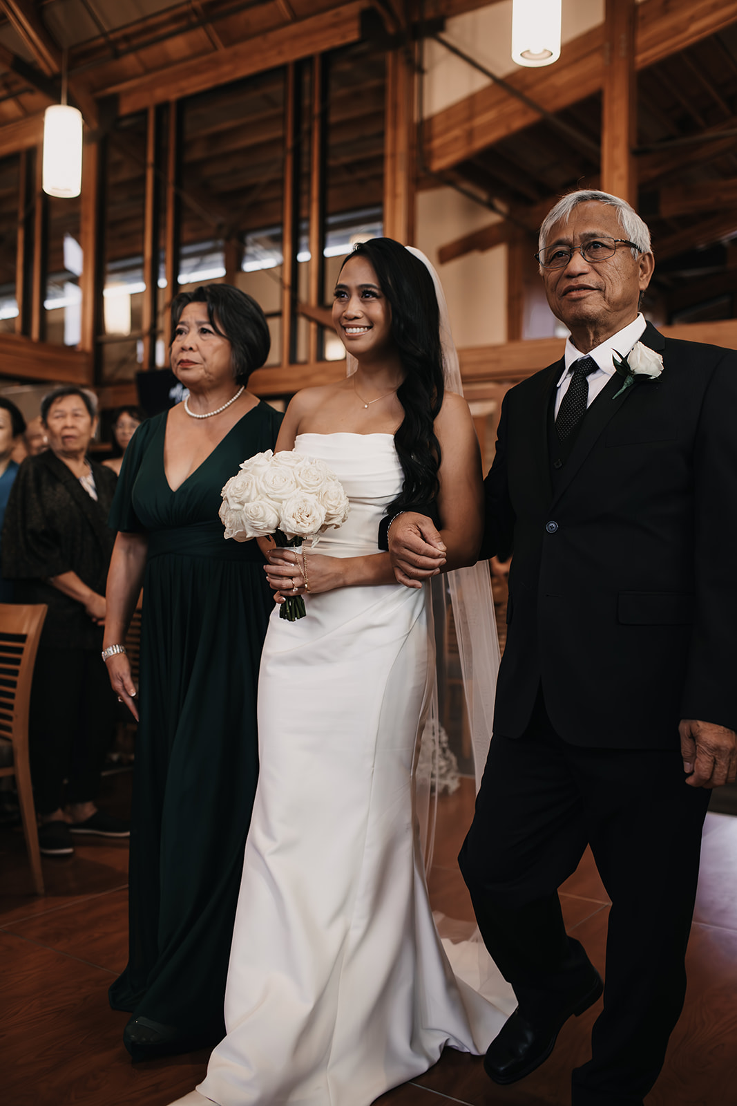 The bride walks down the aisle with her parents, ready for the wedding ceremony, marking the beginning of her special day in her well-planned wedding day timelin